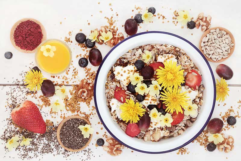 Granola with lemon yogurt and edible flowers