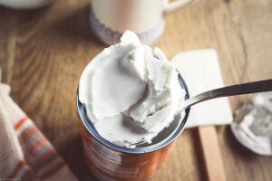 Separate the solid part of your coconut cream cans and place in a blender (reserve the liquid part for a smoothie or a veggie curry).